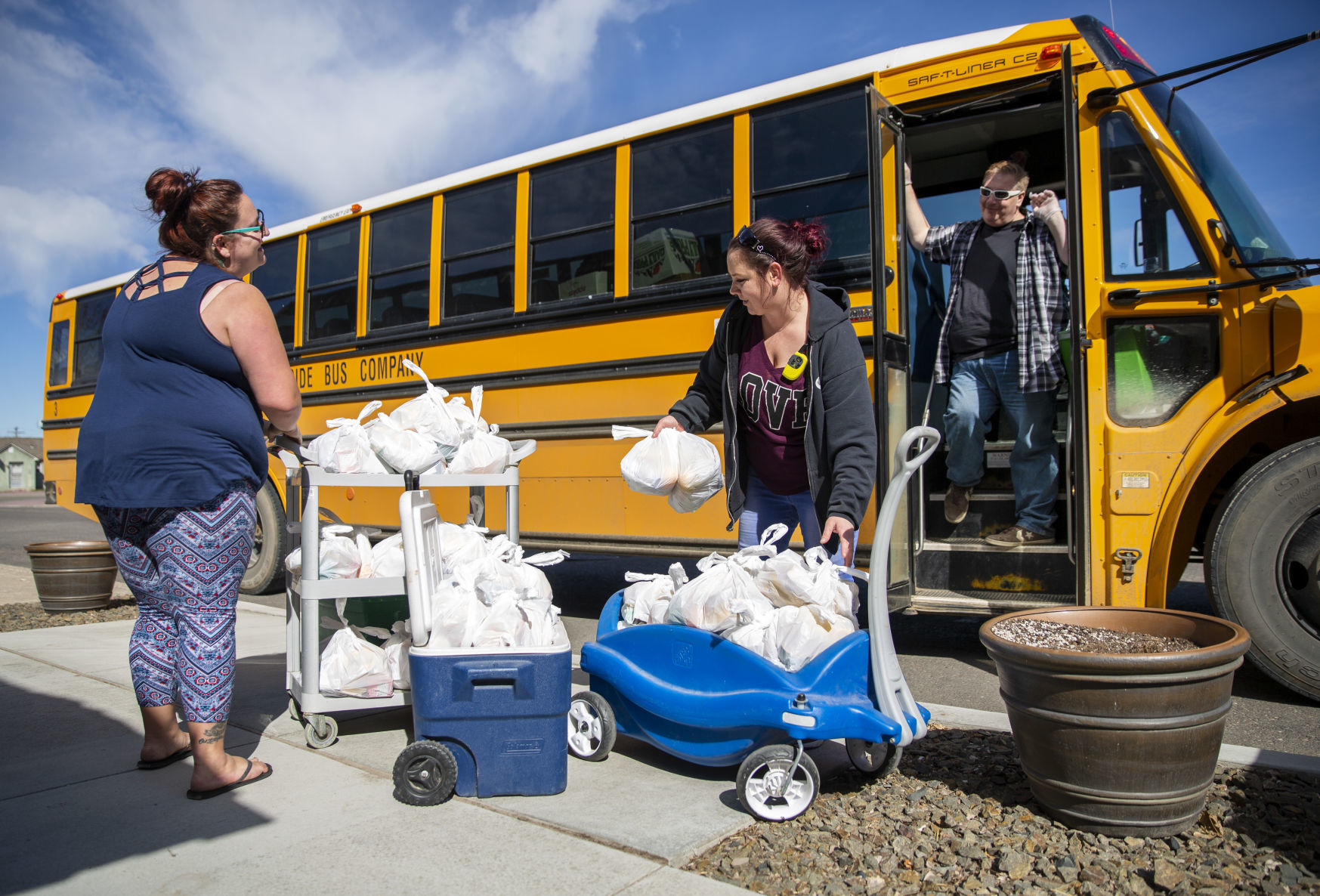 Bus drivers deliver food to students